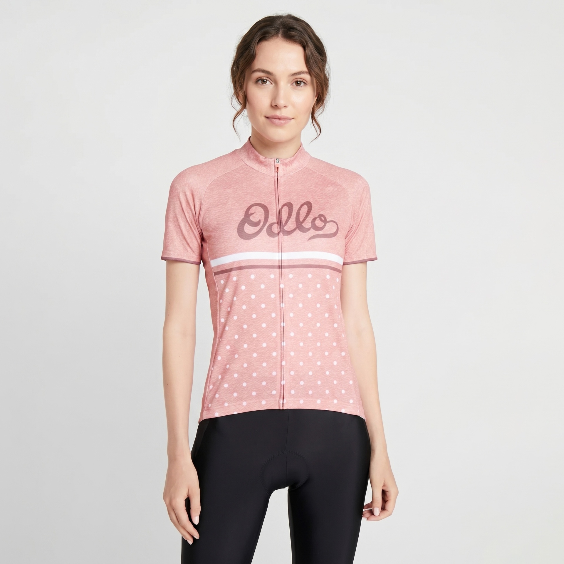 T-shirt ciclismo rosa com padrão de bolinhas branco e texto Odlo na frente