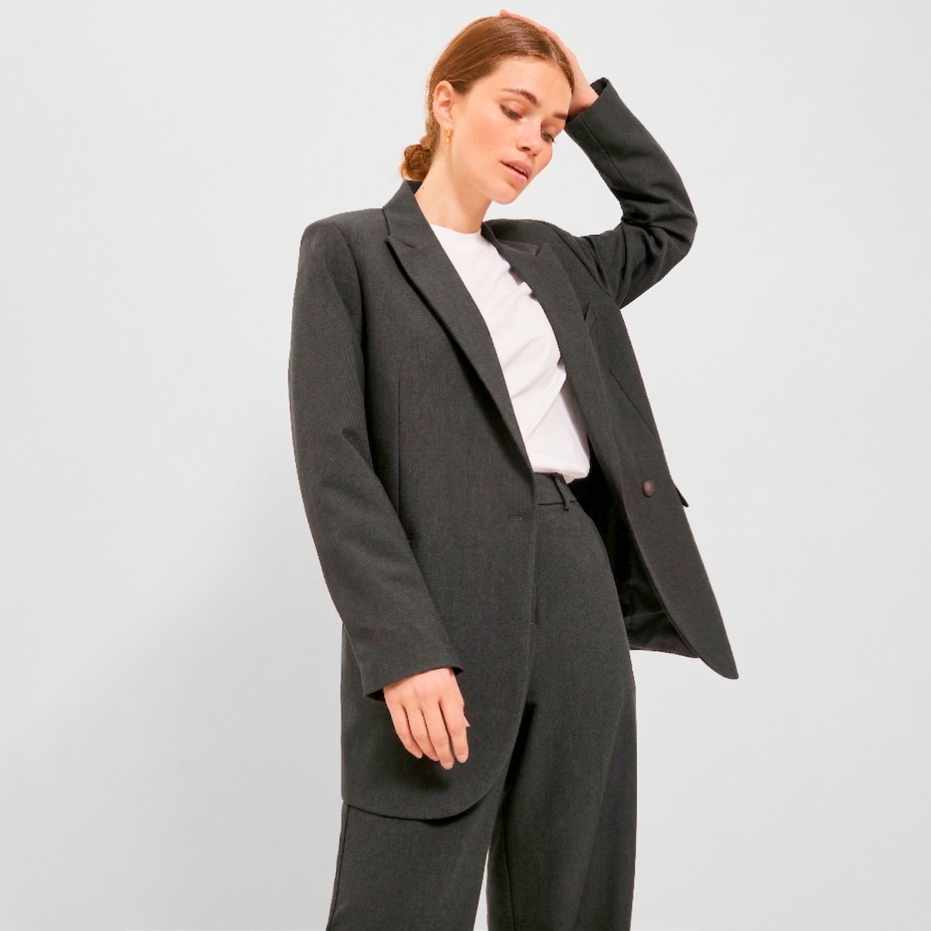 Blazer cinza escuro com calças combinadas em fundo branco