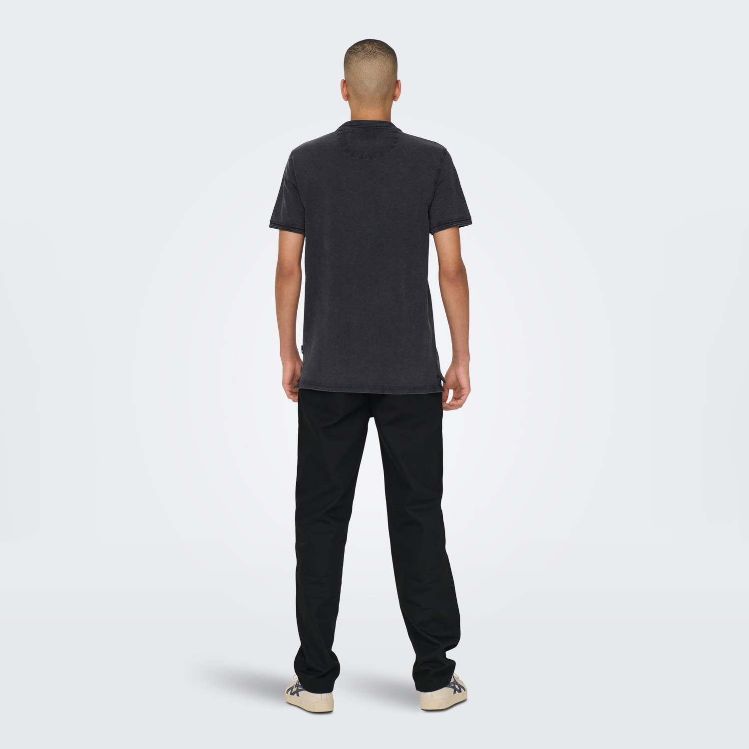 Homem de costas com t-shirt preta e calças pretas