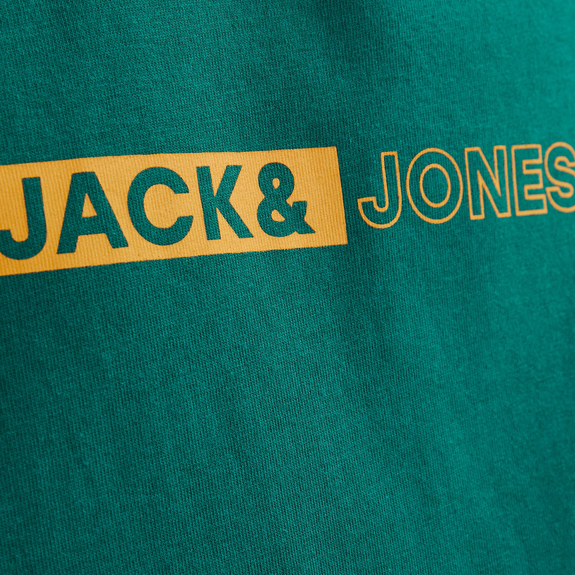 Tecido verde com logo JACK& JONES em amarelo.