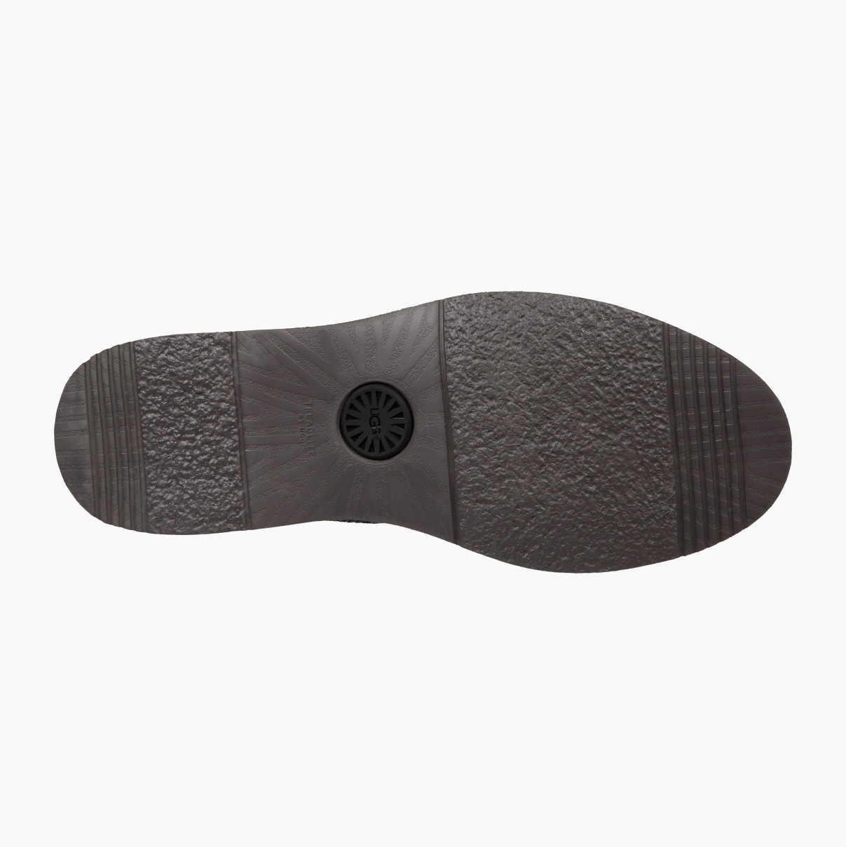 Sola de sapato preta com diversas texturas e padrão circular central