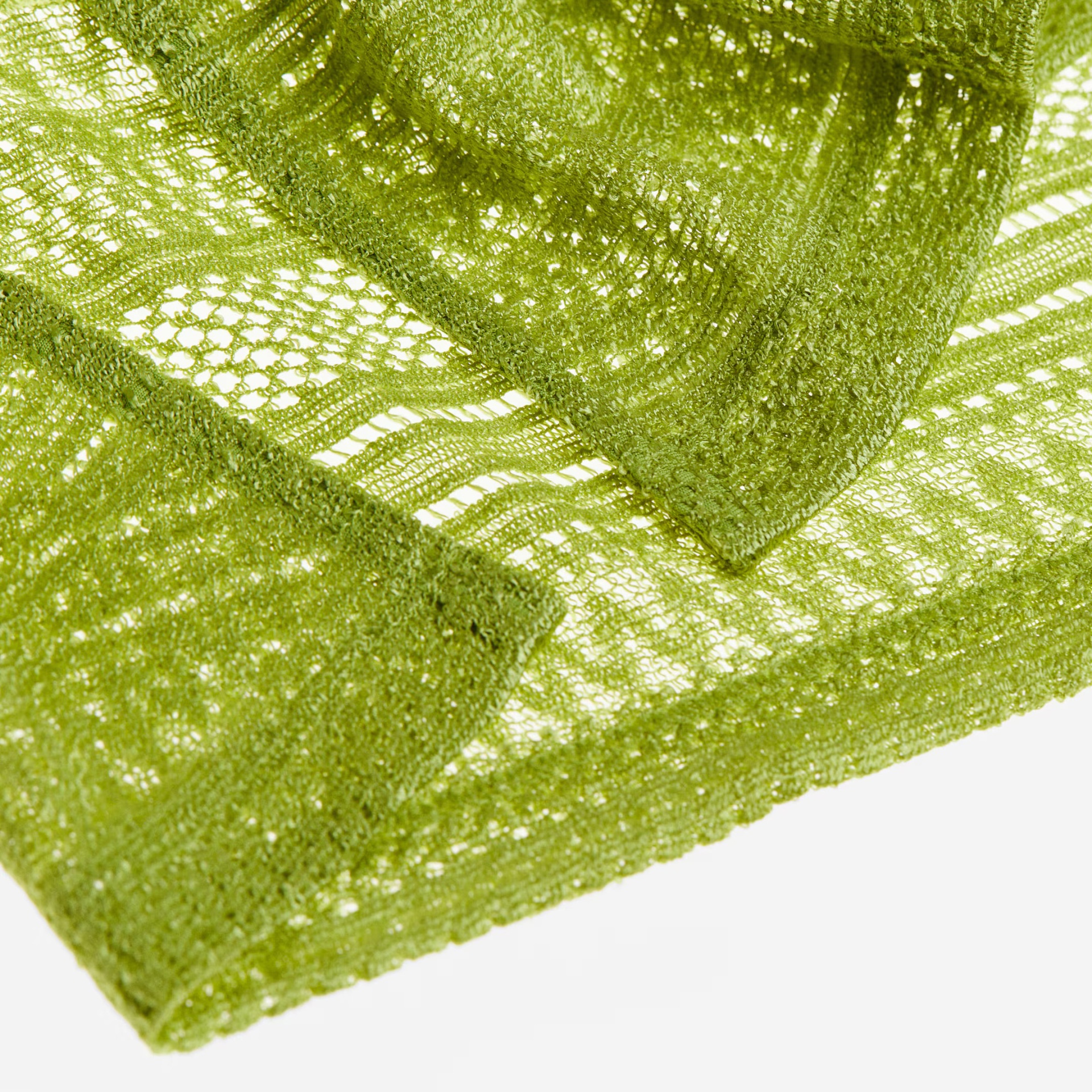 Tecido verde com padrão de malha aberta e textura rendada