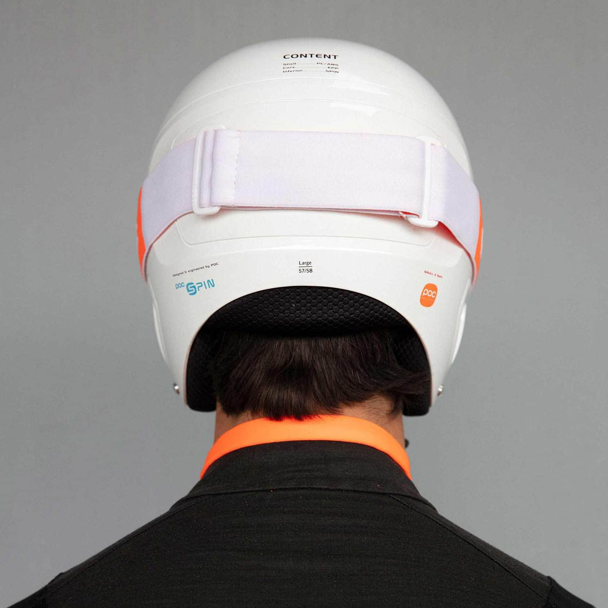 Capacete branco de desporto visto de trás com correia elástica branca e detalhes em laranja