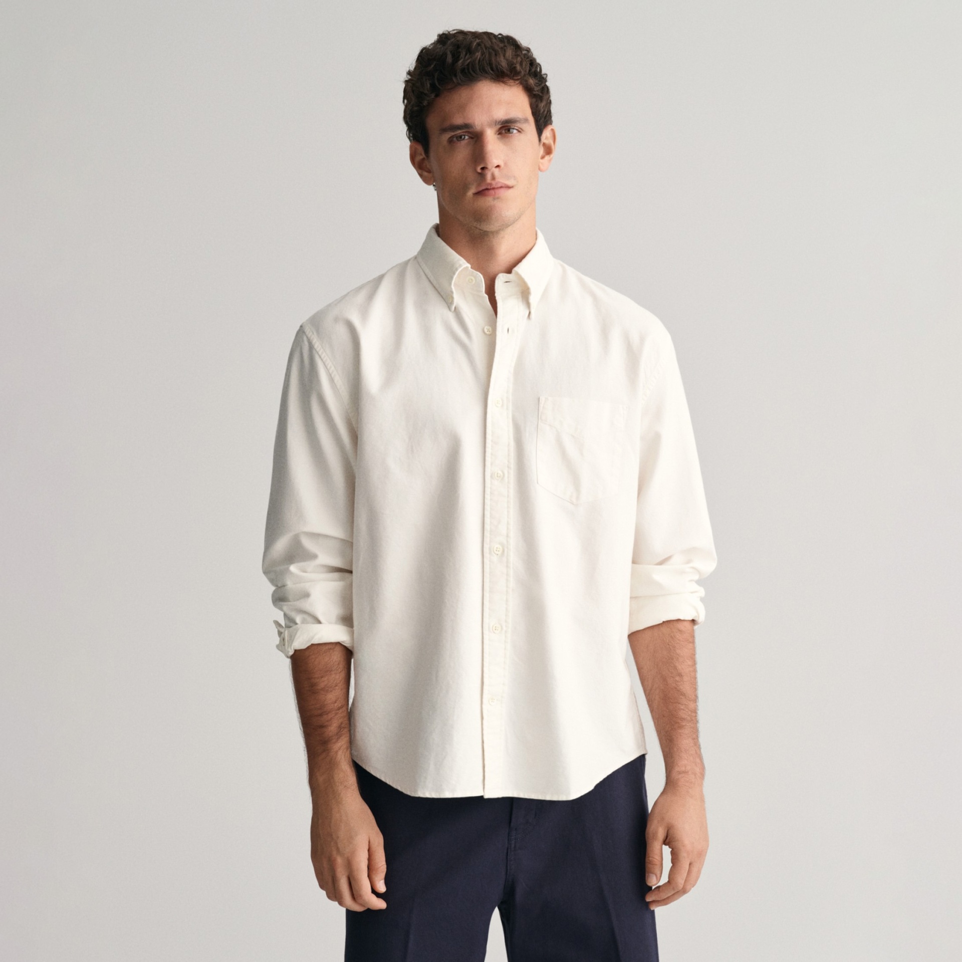 Camisa branca de manga comprida masculina com calças escuras