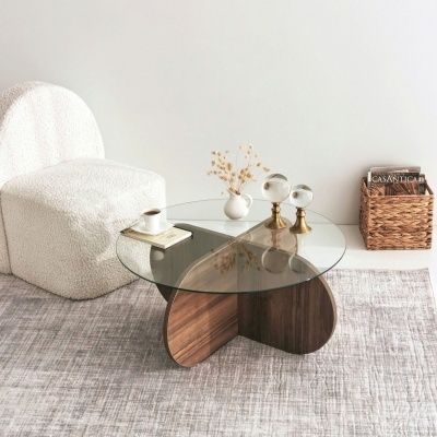 Mesa de centro de vidro e madeira com acessórios decorativos e cadeira branca
