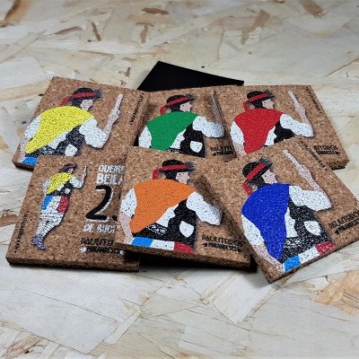 Quadrados de cortiça com ilustração de ciclistas coloridos sobre superfície de madeira