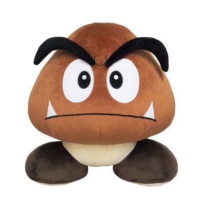Pelúcia castanha do personagem Goomba com olhos brancos e pretos e sobrancelhas negras