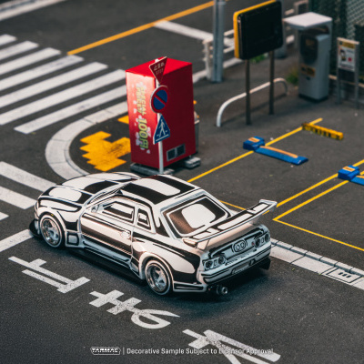 Miniatura de carro desportivo em parque de estacionamento com sinais