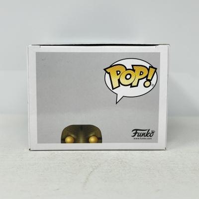 Caixa Funko Pop com figura amarela escamosa e logo POP!