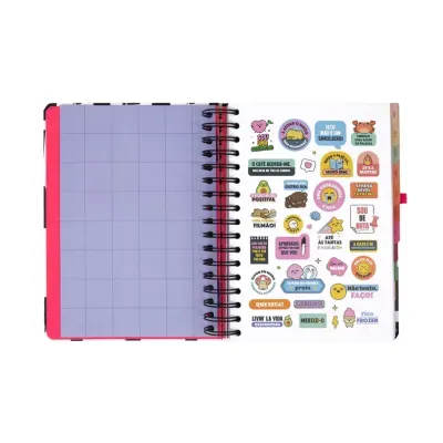 Caderno espiral aberto com autocolantes coloridos e página de tabela lilás