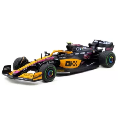 Miniatura de carro de Fórmula 1 preta, amarela e rosa com várias inscrições visíveis