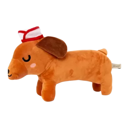 Pelúcia de cão castanho com chapéu branco e detalhe vermelho