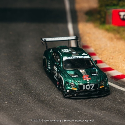 Carro de corrida em miniatura verde metálico numa pista de corrida