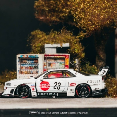 Miniatura de carro desportivo branco com texto LIBERTY WALK e número 23 numa rua urbana com árvores e máquinas automáticas