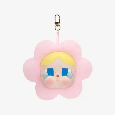 Chaveiro de pelúcia rosa em forma de flor com cara de boneca no centro