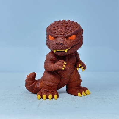 Figura de ação de dinossauro ou monstro marrom escamoso com olhos laranja e garras amarelas
