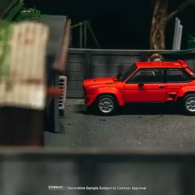 Miniatura de carro desportivo vermelho numa diorama de rua