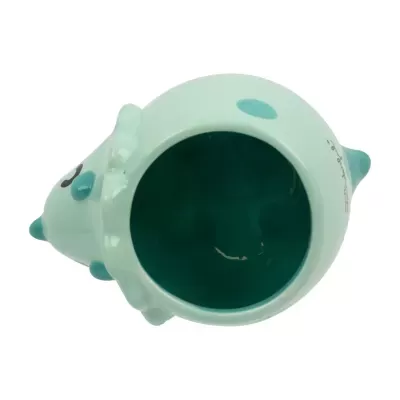 Caneca de cerâmica azul clara em forma de dinossauro vista de cima