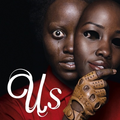 Pessoa com máscara facial realista e luva de couro segurando a máscara, fundo preto, texto Us