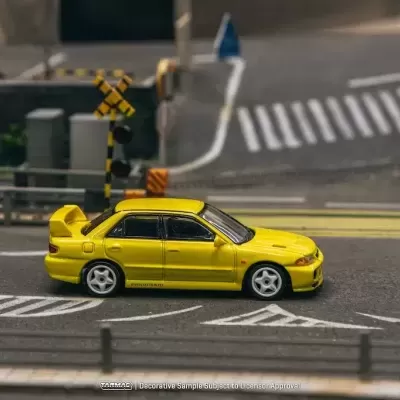 Carro desportivo amarelo em miniatura numa maquete urbana