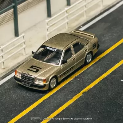 Miniatura de carro dourado com marcações de corrida numa pista