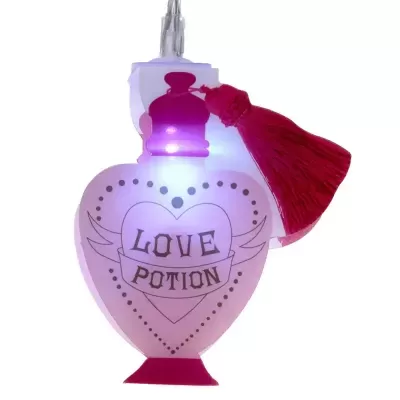 Frasco rosa em forma de coração com texto LOVE POTION e tassel vermelho