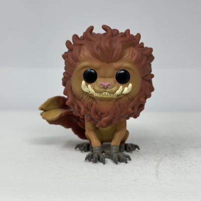 Figura de vinil castanha com olhos negros e presas amarelas