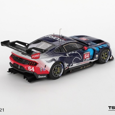 Miniatura de carro de corrida Ford azul com detalhes vermelhos e brancos e o número 64 em fundo branco.