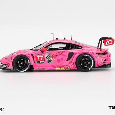 Miniatura de carro Porsche rosa com número 77 e detalhes de corrida.