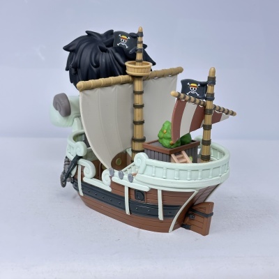 Barco em miniatura de plástico com velas e bandeiras de pirata