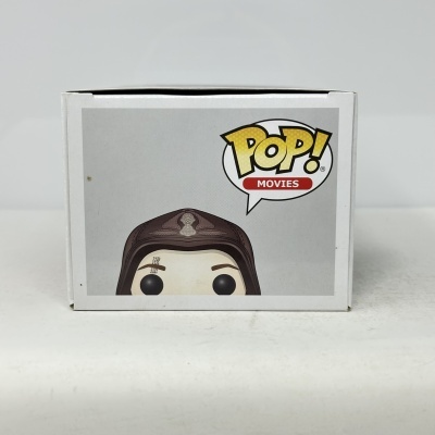 Caixa de Funko Pop! Movies em cartão branco com imagem parcial da figura numa cor marrom e bege.
