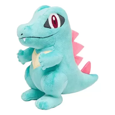 Pelúcia de dinossauro azul-claro com detalhes rosa e olhos bordados