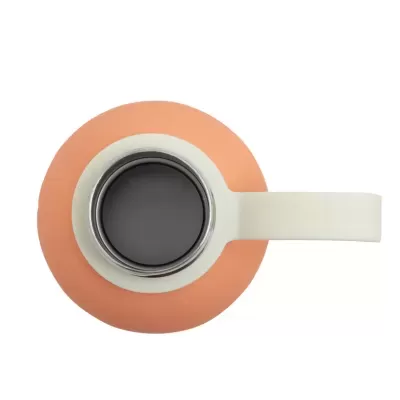Xícara branca vista de cima com café e pires laranja.