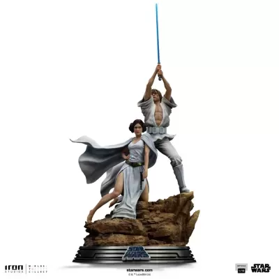 Estatueta Star Wars com personagens em poses heroicas sobre base de rochas castanhas.