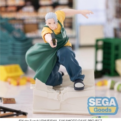 Figura de ação de personagem com avental verde em pose dinâmica sobre base branca rachada.