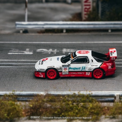 Carro de corrida em miniatura branco e vermelho numa pista de corrida em miniatura