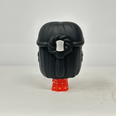 Figura colecionável Funko Pop de cabelo preto e vestido vermelho com bolinhas brancas vista de trás