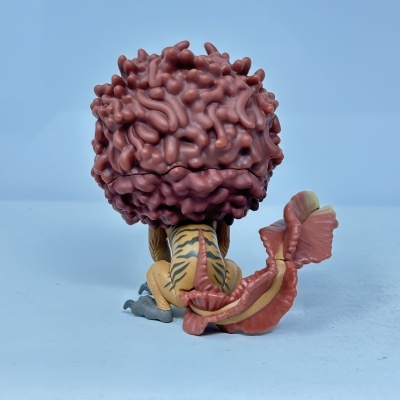 Figura colecionável amarela com cabeça rosa texturizada e cauda grande cor de rosa