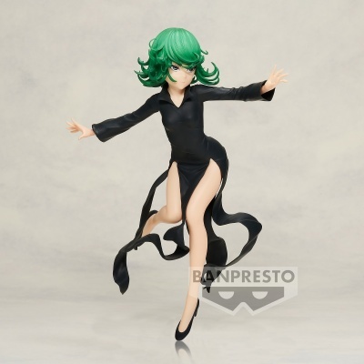 Figura de ação com cabelo verde e vestido preto em fundo neutro.