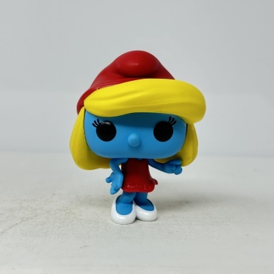 Boneco de vinil azul com cabelo amarelo e vestido vermelho