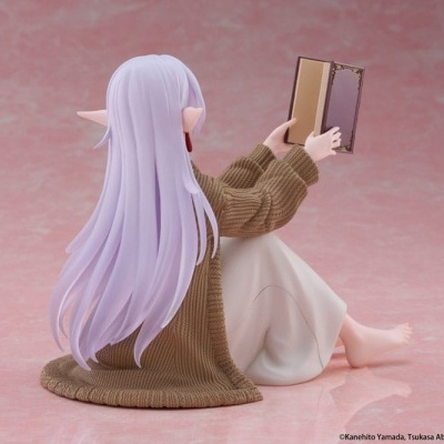 Figura colecionável de personagem sentada com cabelos lilás e a ler um livro