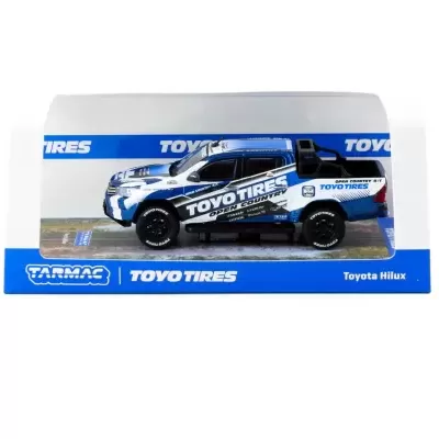 Miniatura Toyota Hilux branca e azul com logotipo Toyo Tires em embalagem