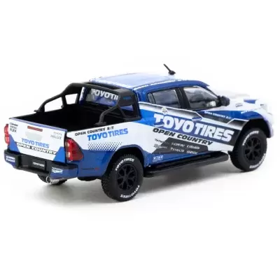 Miniatura de pick-up Toyota Hilux azul, branca e preta com logótipo TOYO TIRES