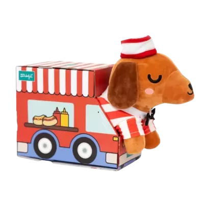 Brinquedo de peluche cão com caixa ilustrada como carrinha de venda