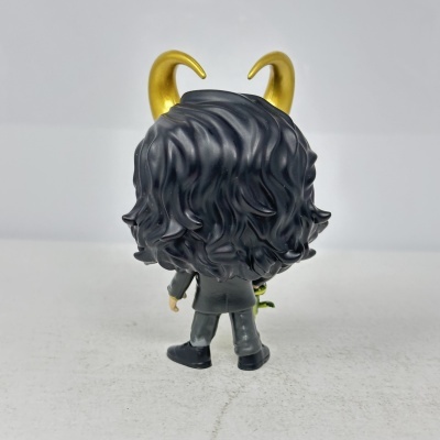 Figura de brinquedo de costas com cabelo preto e chifres dourados