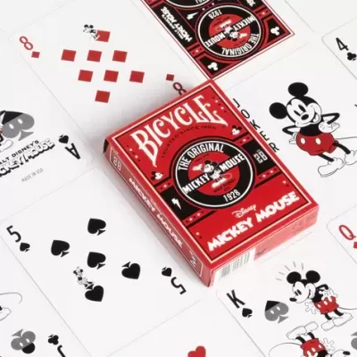 Baralho Bicycle vermelho com tema Mickey Mouse e cartas espalhadas.