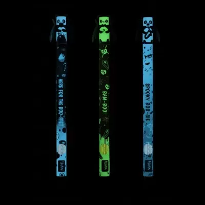 Três pulseiras luminescentes com desenhos de panda e textos em inglês no fundo negro.