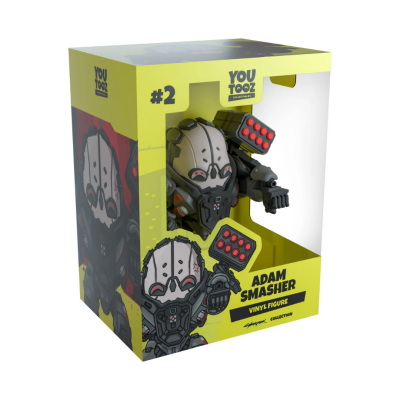Boneco de vinil Adam Smasher na embalagem amarela e preta You Tooz
