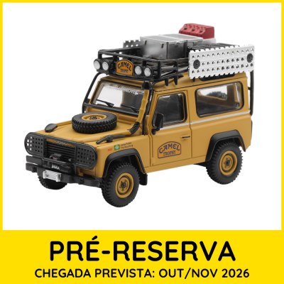 Miniatura de carro 4x4 amarelo com acessórios no teto e texto Camel Trophy