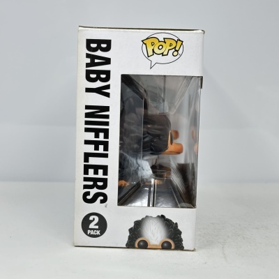 Caixa Funko Pop Baby Nifflers branca com janela mostrando figura dentro.